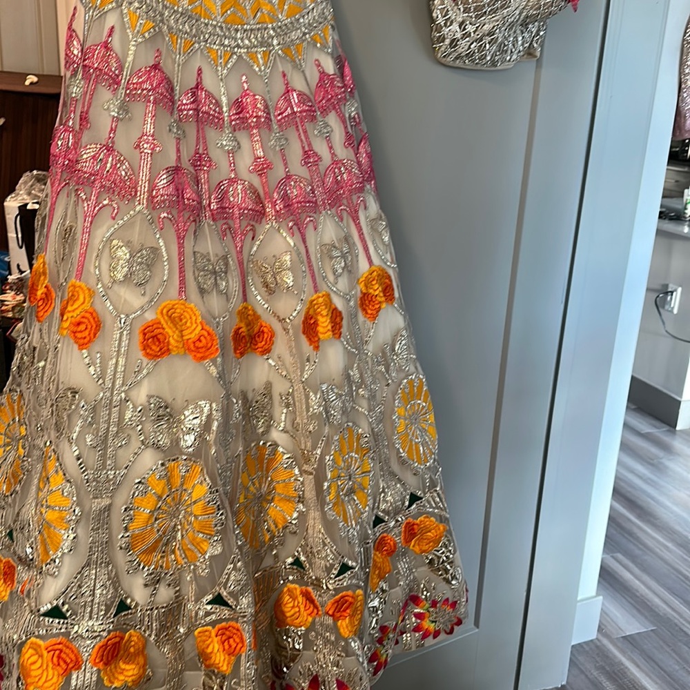 Gorgeous orange and pink Falguni Shane Peacock Lengha with feather dupatta